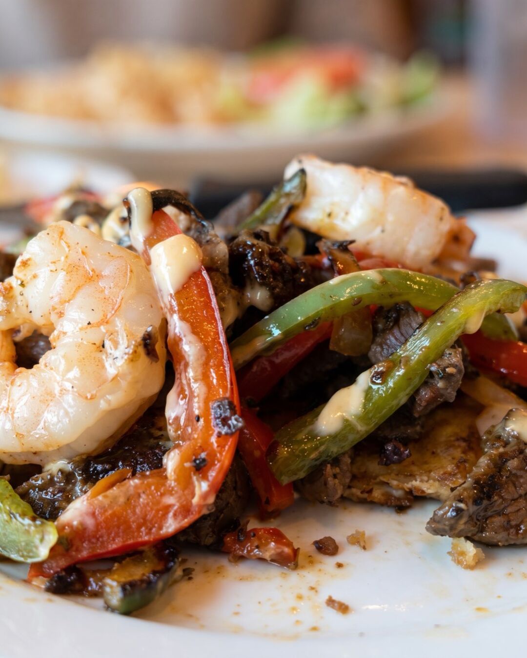 Steak and shrimp with peppers and onions