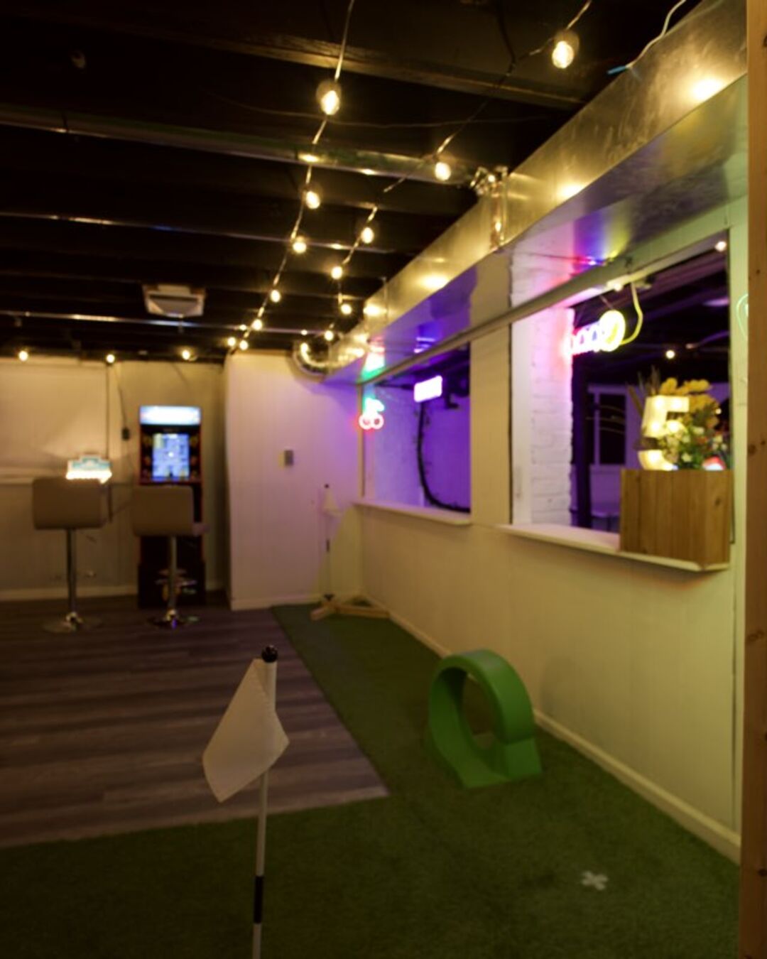 The indoor mini golf course in the basement