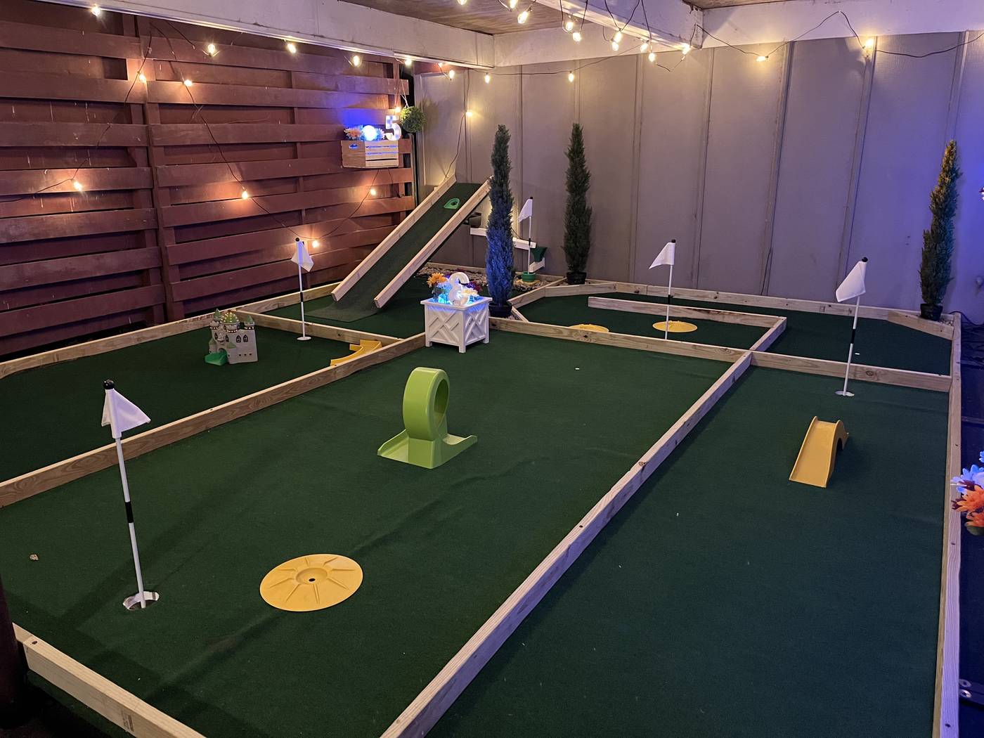 The covered mini golf course at night