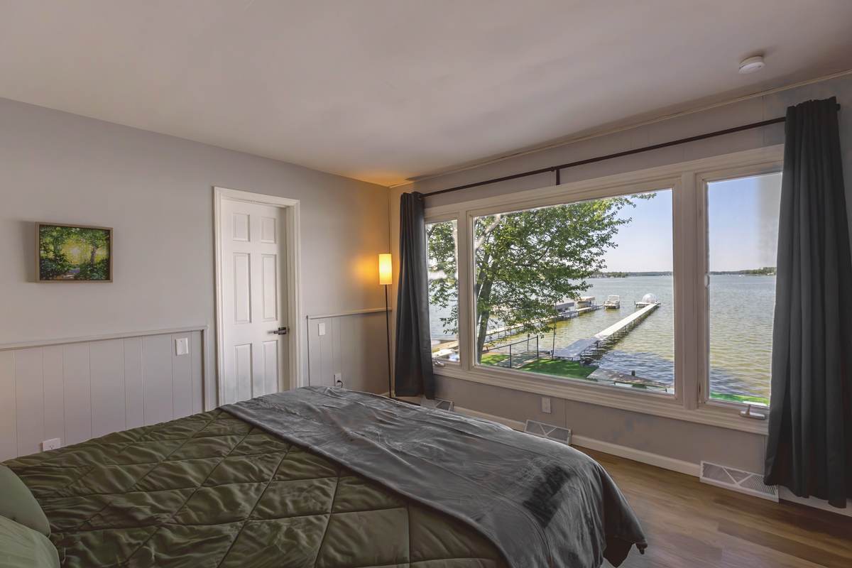 King bedroom with a picture-window view of the lake