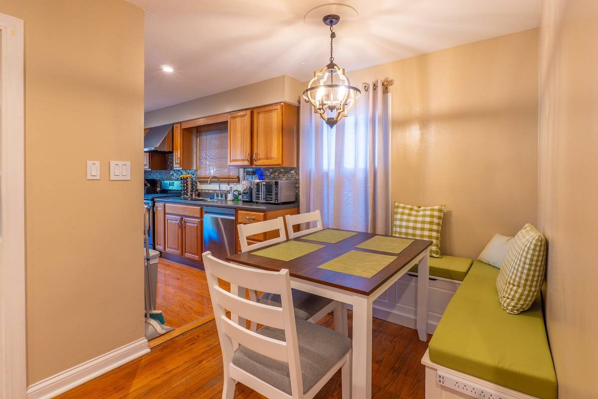 Dining nook with a built-in banquette, open to the kitchen