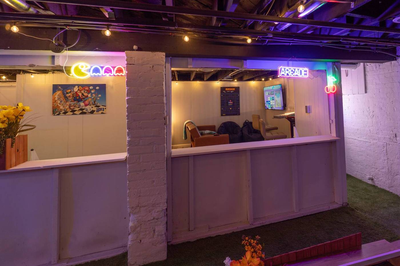 The basement course and bar seating under the neon signs