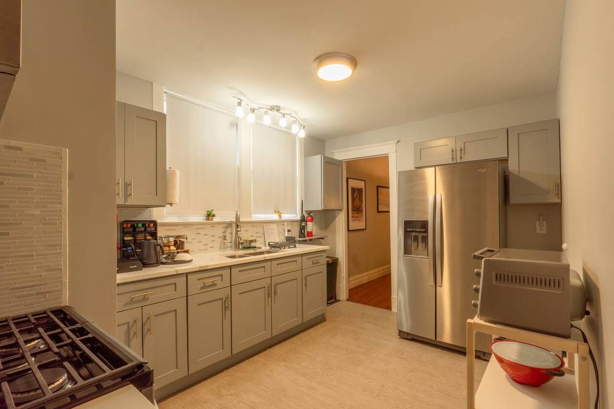Kitchen with gas range and full-size fridge