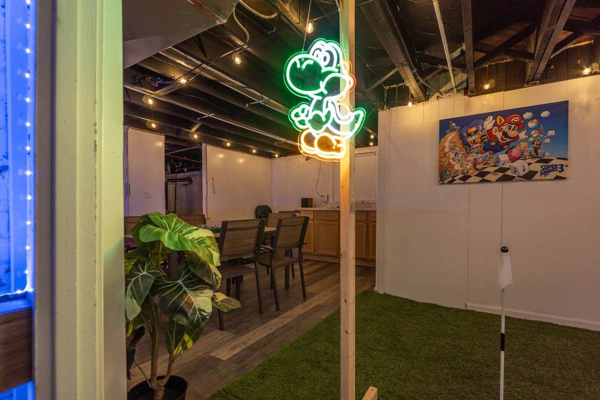A hole on the basement course under the neon signs